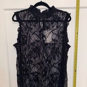 Sleeveless lace blouse.
